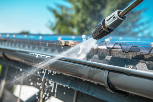 Spring,Rain,Gutters,Cleaning,Using,Pressure,Washer.,Closeup,Photo.